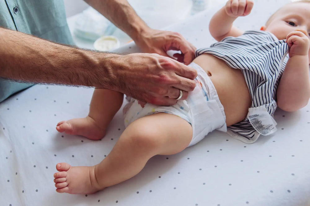 A parent looking at a clean baby nappy