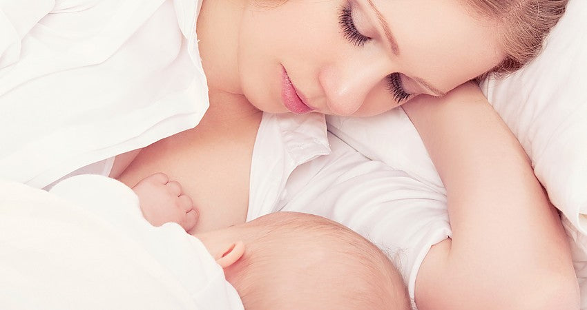 A parent breastfeeding their baby