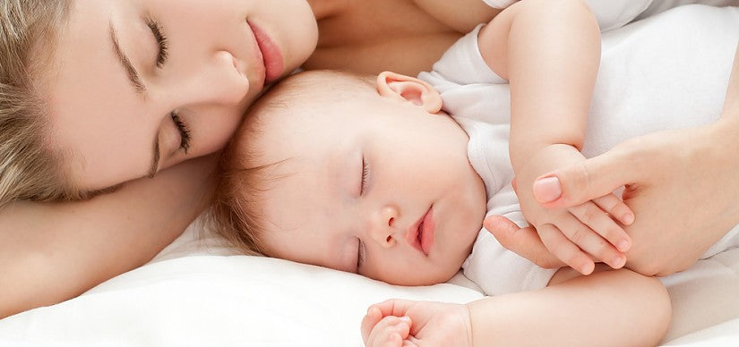 A tired parent with a baby awake at night