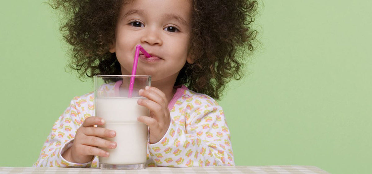 Goat milk formula next to a bottle of fresh milk
